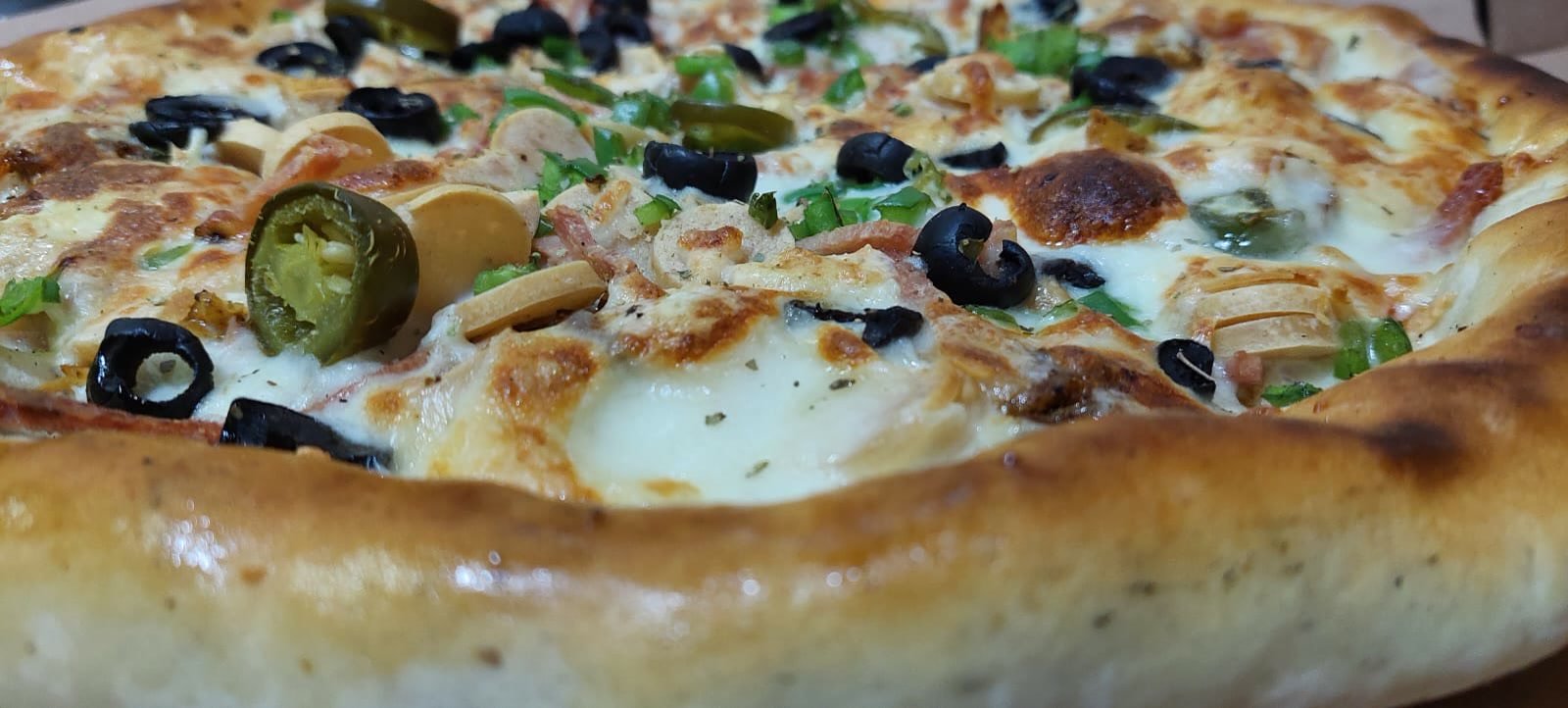 A Royal Majestical pizza with a cheese filled edge, jalapeno and chicken.